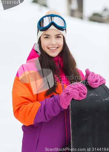 Image of happy young woman with snowboard outdoors