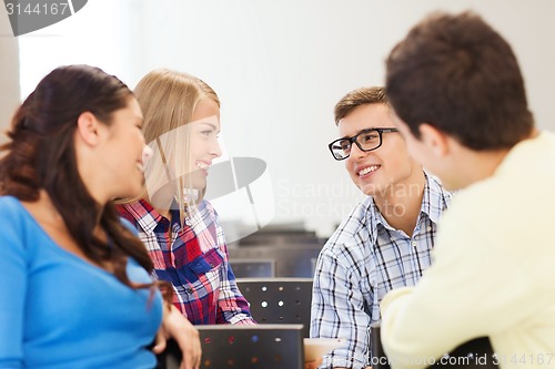 Image of group of smiling students in lecture hall
