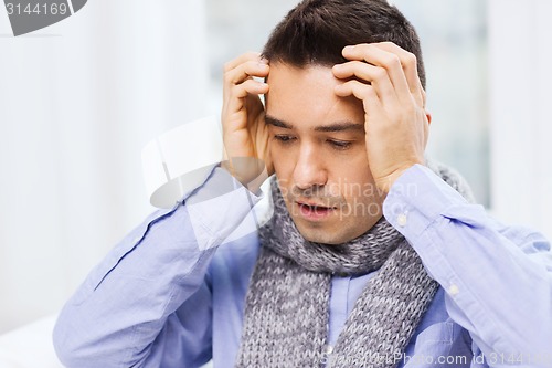 Image of close up of ill man with flu and headache at home