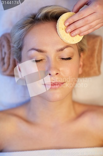 Image of close up of woman having face massage in spa