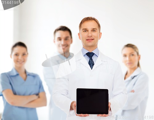 Image of smiling male doctor with tablet pc