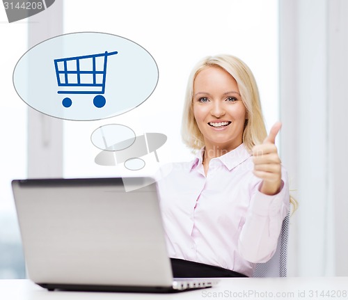 Image of happy businesswoman with laptop showing thumbs up