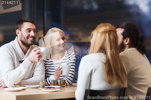 Image of happy friends meeting and drinking tea or coffee