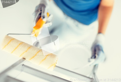 Image of woman with roller and paint pot