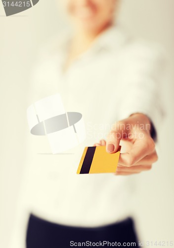 Image of woman showing gold credit card