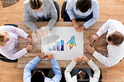 Image of close up of business team sitting at table