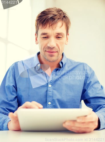 Image of man working with tablet pc at home