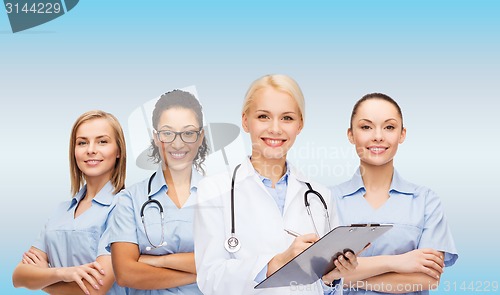 Image of smiling female doctor and nurses with stethoscope