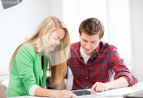 Image of students looking at tablet pc at school