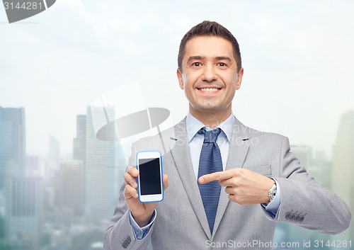 Image of happy businessman showing smartphone screen