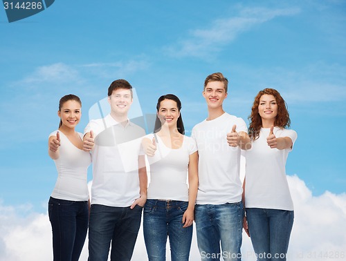 Image of smiling teenagers in t-shirts showing thumbs up