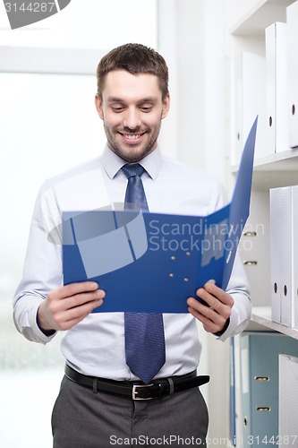 Image of businessman with folder at office