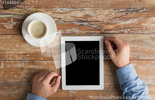 Image of close up of male hands with tablet pc and coffee