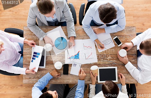 Image of close up of business team with coffee and papers