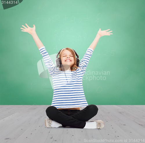 Image of happy girl with headphones listening to music