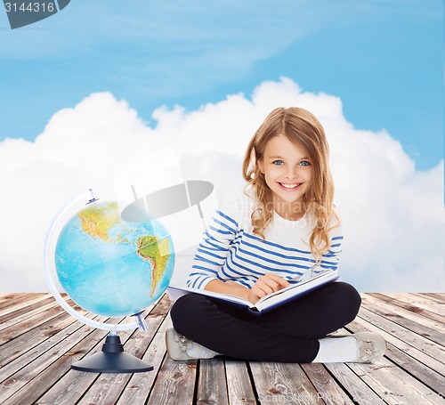 Image of girl with globe and book