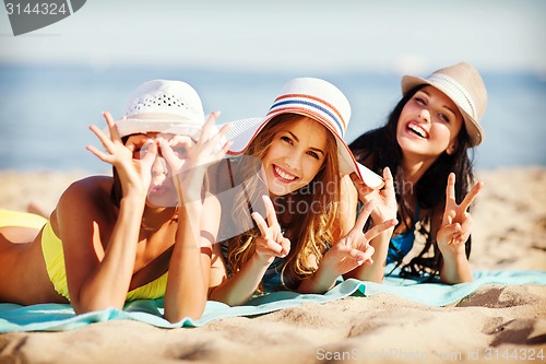 Image of girls sunbathing on the beach