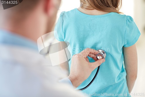 Image of close up of girl and doctor on medical exam