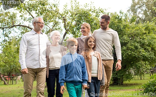 Image of happy family in front of house outdoors