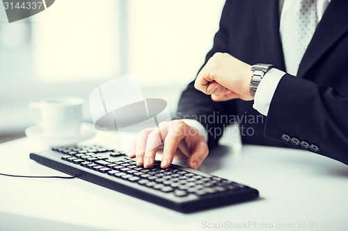 Image of man hands typing on keyboard
