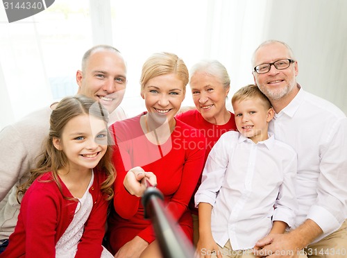 Image of smiling family making selfie at home