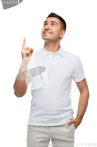 Image of smiling man pointing finger up