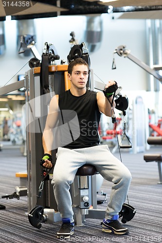 Image of man exercising on gym machine