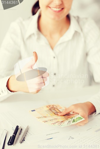 Image of woman hands with euro cash money and thumbs up