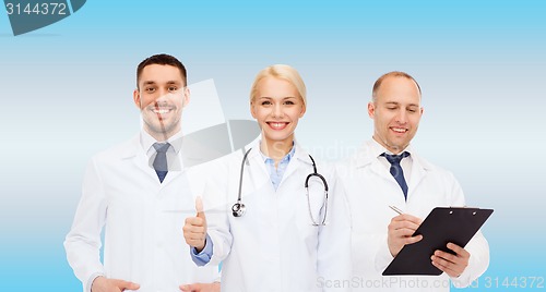 Image of group of doctors showing thumbs up in clinic