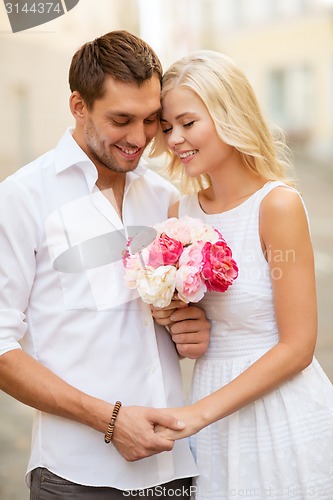 Image of couple with flowers in the city