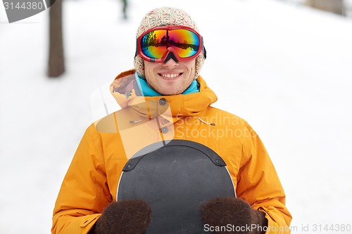 Image of happy young man in ski goggles outdoors