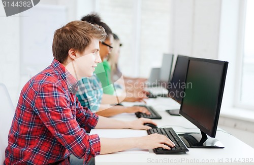 Image of student with computer studying at school