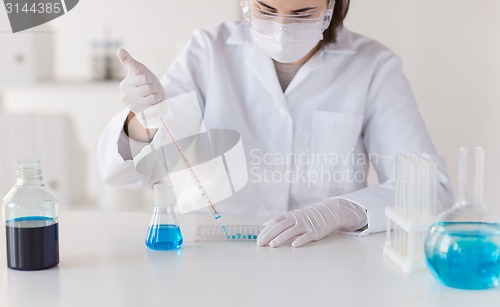 Image of close up of scientist making test in lab