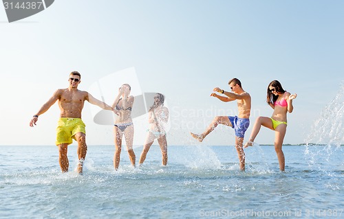 Image of happy friends having fun on summer beach