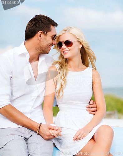 Image of couple in shades at seaside