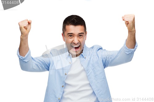 Image of happy laughing man with raised hands