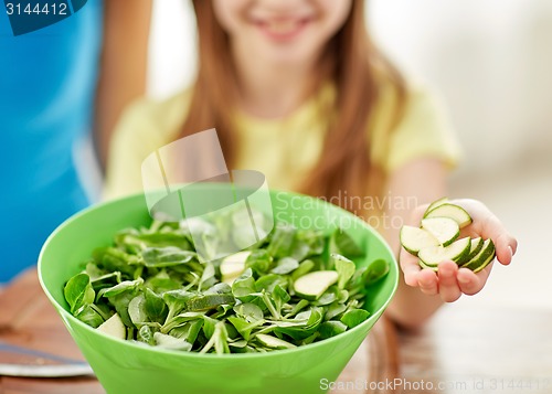 Image of close up of happy family making dinner in kitchen