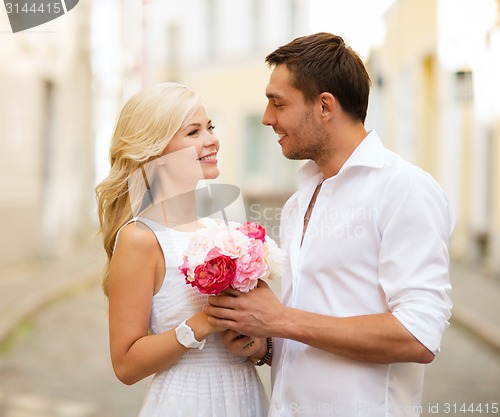 Image of couple with flowers in the city