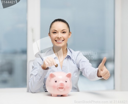 Image of smiling woman with piggy bank and cash money