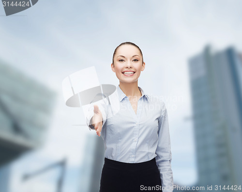 Image of businesswoman with opened hand ready for handshake