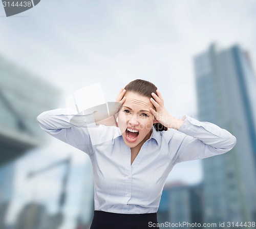 Image of angry screaming businesswoman outdoors