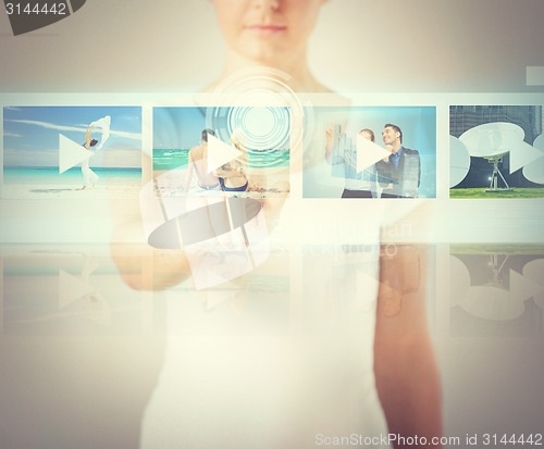 Image of woman pressing button on virtual screen