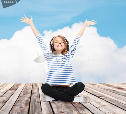 Image of happy girl with headphones listening to music