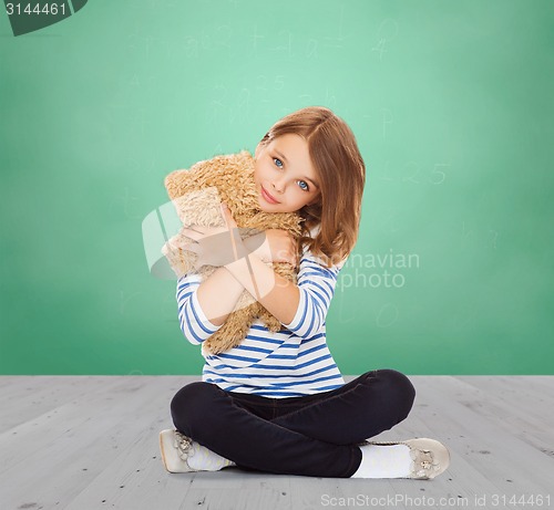 Image of cute little girl hugging teddy bear