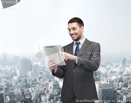 Image of smiling buisnessman with tablet pc computer