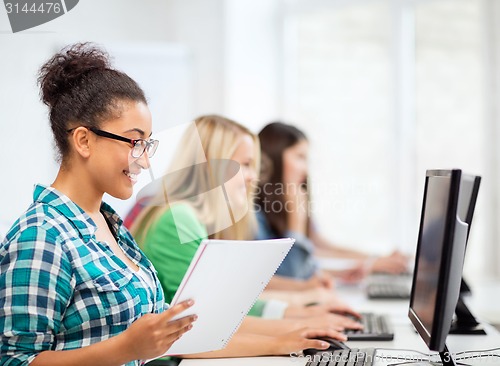 Image of african student with computer studying at school