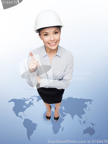 Image of businesswoman in white helmet with finger up