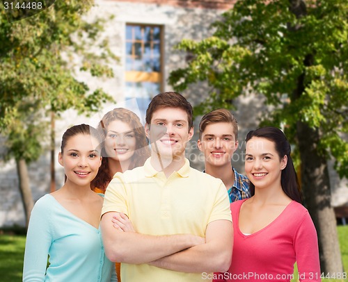 Image of group of smiling teenagers over campus background