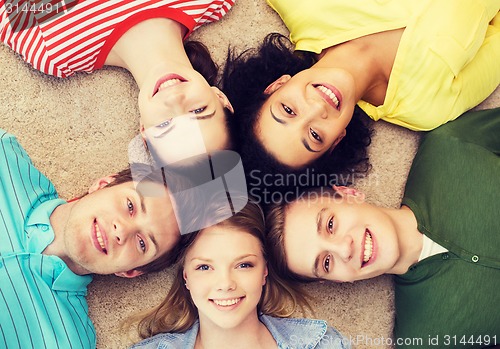 Image of group of smiling people lying down on floor