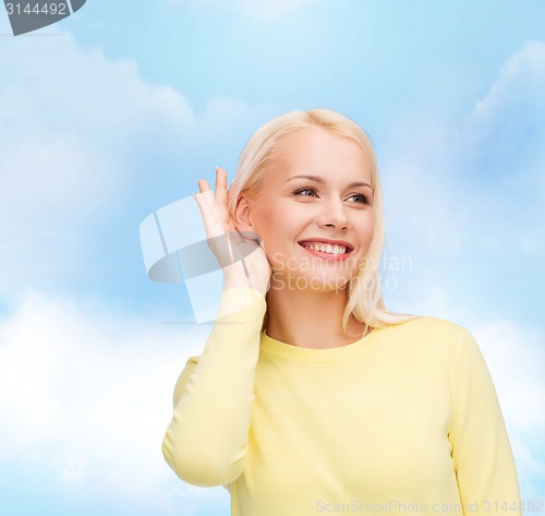 Image of smiling young woman listening to gossip